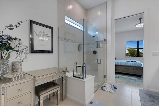 bathroom with a shower with door and tile patterned floors