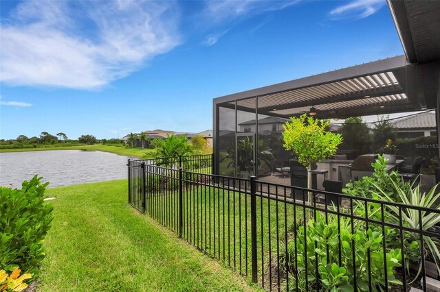 view of yard with a pergola and a water view