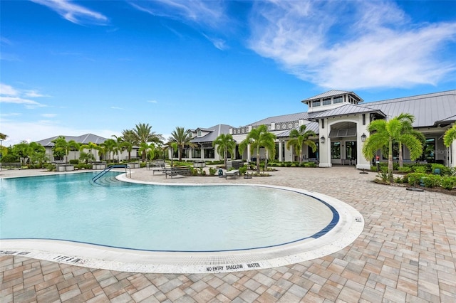 view of swimming pool with a patio