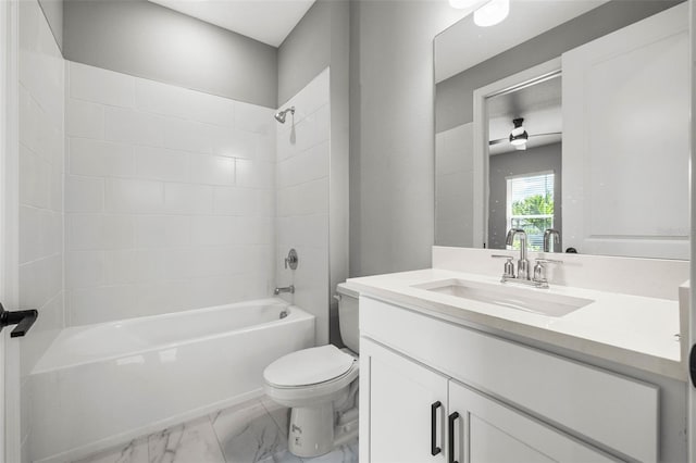 full bathroom featuring vanity, tiled shower / bath combo, and toilet