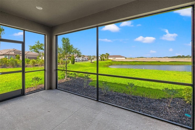 unfurnished sunroom with a water view