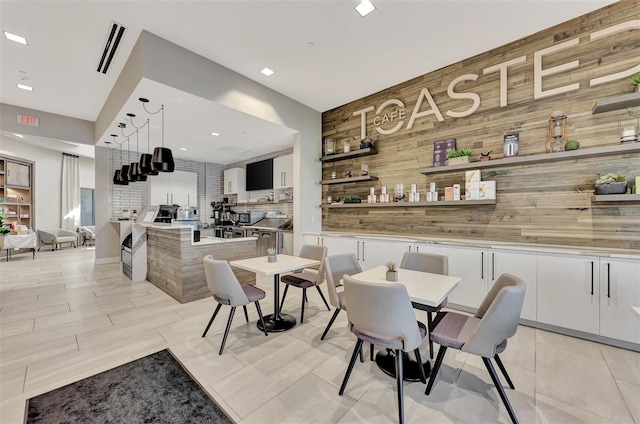 dining space featuring wood walls