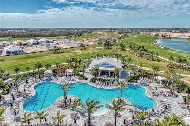 view of swimming pool featuring a water view and a patio area