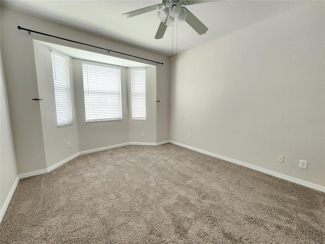 empty room with ceiling fan and light colored carpet