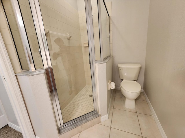 bathroom with walk in shower, tile patterned flooring, and toilet