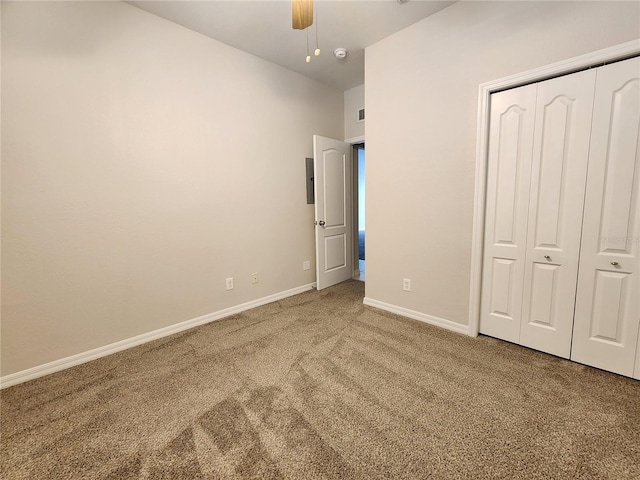 unfurnished bedroom featuring ceiling fan, carpet floors, and a closet