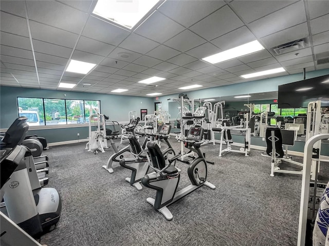 workout area featuring carpet floors and a paneled ceiling