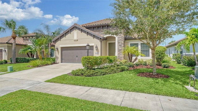 mediterranean / spanish house with concrete driveway, a front lawn, stucco siding, and a garage