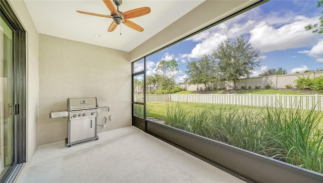 unfurnished sunroom with a ceiling fan