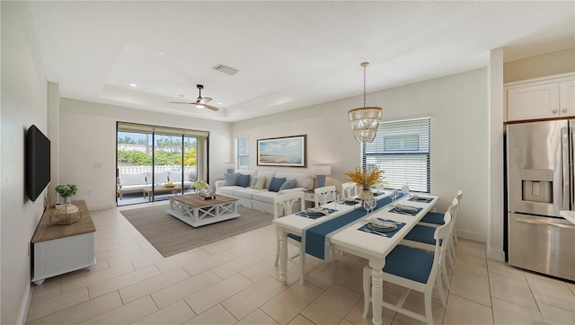 dining room featuring recessed lighting, light tile patterned floors, a raised ceiling, baseboards, and ceiling fan with notable chandelier