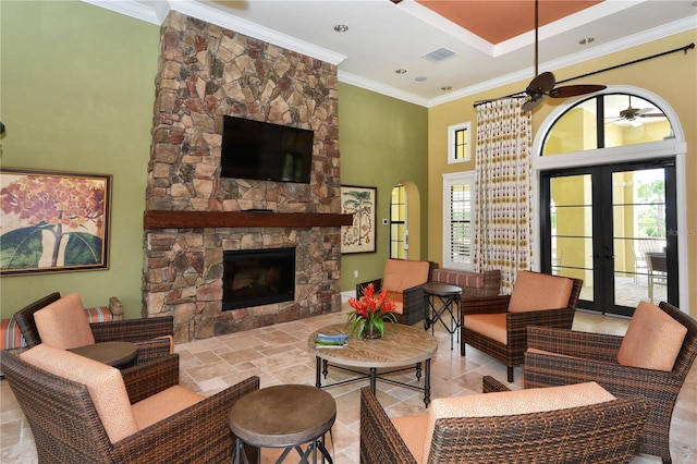 living room with french doors, a fireplace, ornamental molding, and a wealth of natural light