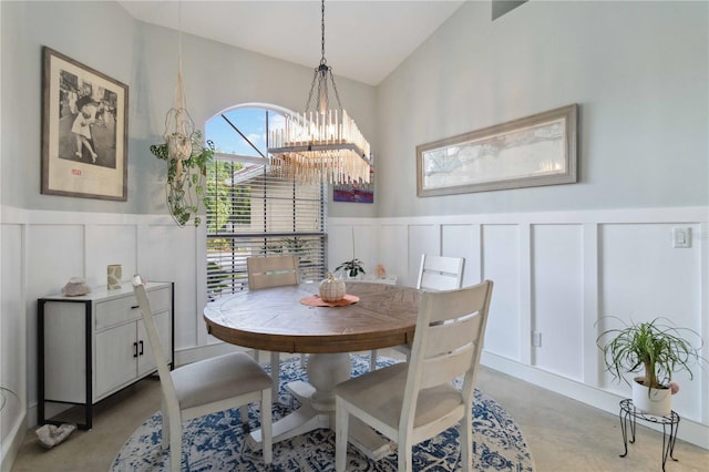 dining area featuring lofted ceiling and a chandelier