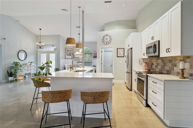 kitchen with white cabinets, a kitchen island with sink, stainless steel appliances, and sink