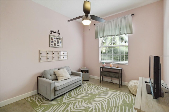 living area with ceiling fan and light colored carpet