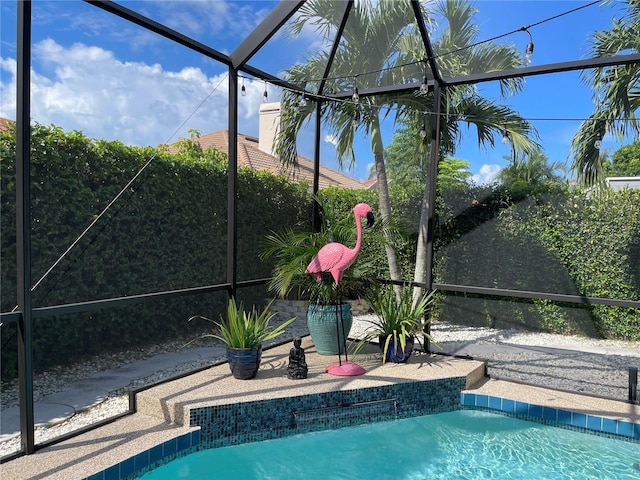 view of swimming pool with a patio and a lanai