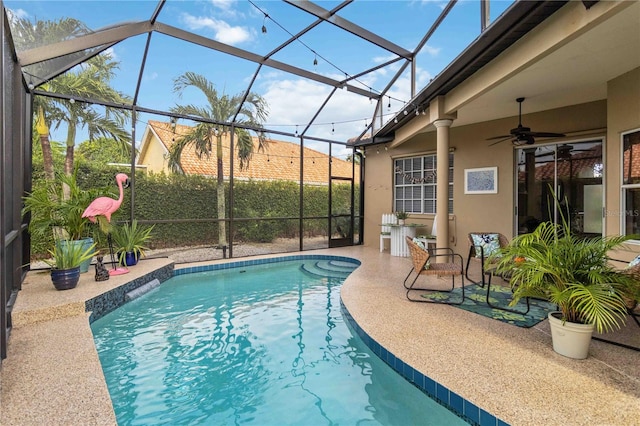 view of swimming pool with a lanai, ceiling fan, and a patio area