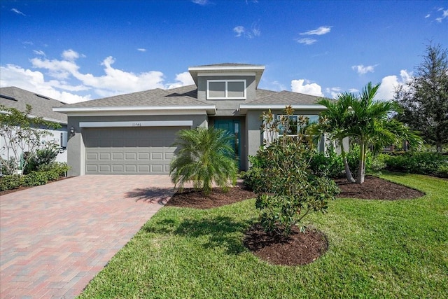 view of front of house featuring a front yard and a garage