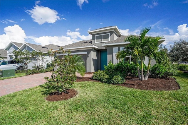 view of front of property with a front yard and a garage