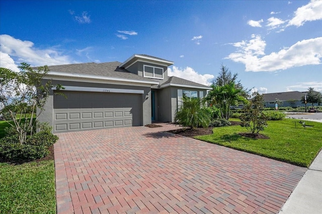 view of front of home with a front lawn and a garage