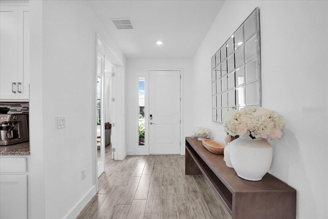 foyer featuring recessed lighting, baseboards, visible vents, and light wood finished floors