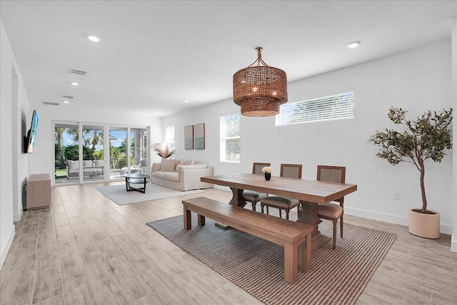 dining area featuring a notable chandelier, light wood finished floors, recessed lighting, baseboards, and visible vents
