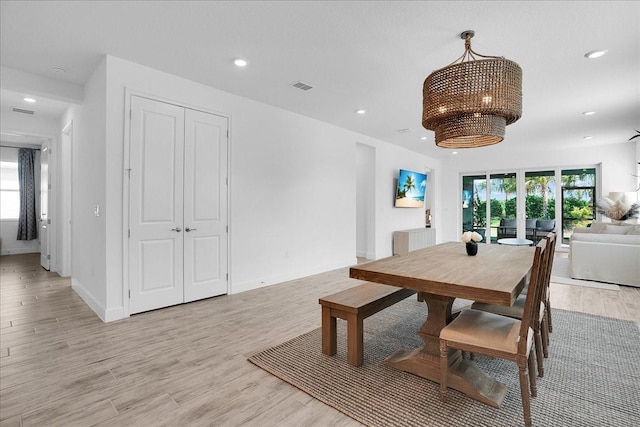 dining room with an inviting chandelier, light wood-style flooring, recessed lighting, baseboards, and visible vents