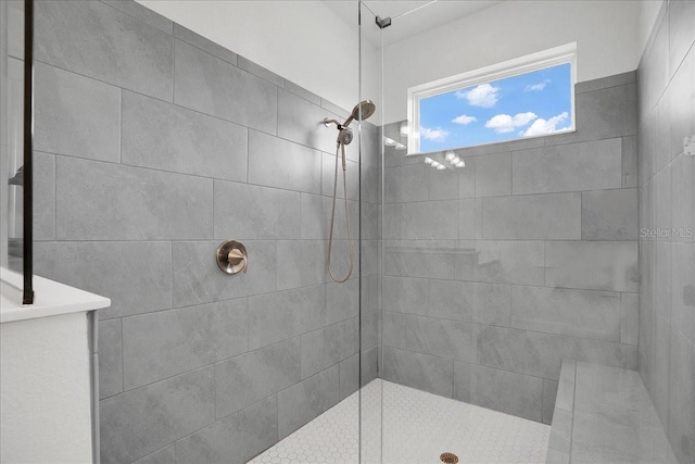full bath featuring a tile shower