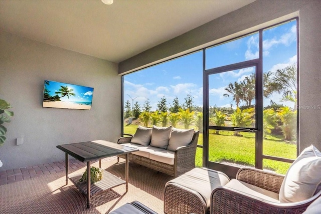 sunroom featuring a healthy amount of sunlight and an outdoor hangout area