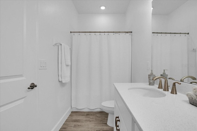 full bath with vanity, baseboards, wood finished floors, and toilet