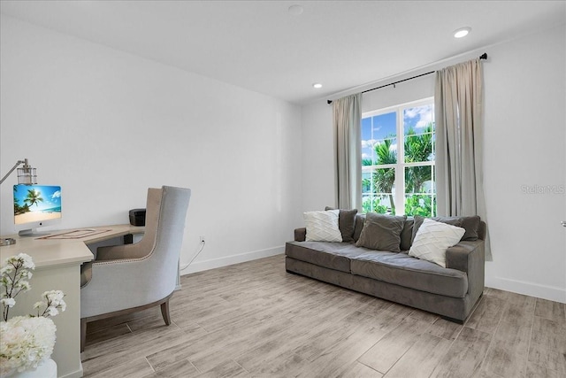office space featuring recessed lighting, baseboards, and light wood finished floors