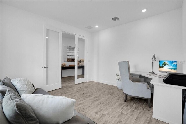 home office with visible vents, recessed lighting, light wood-style flooring, and french doors