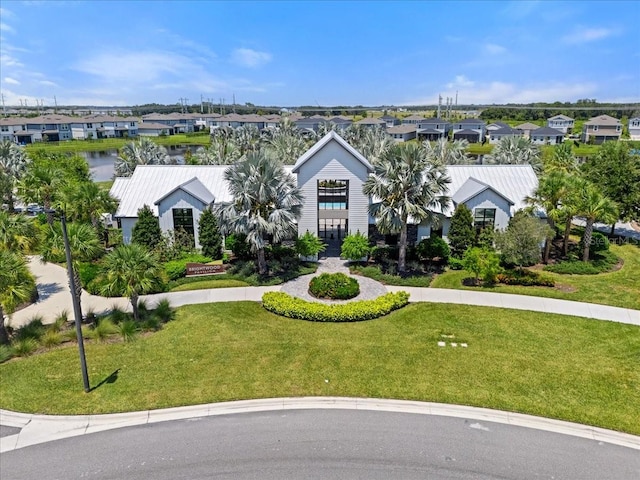 view of front of property with a residential view, french doors, and a front lawn
