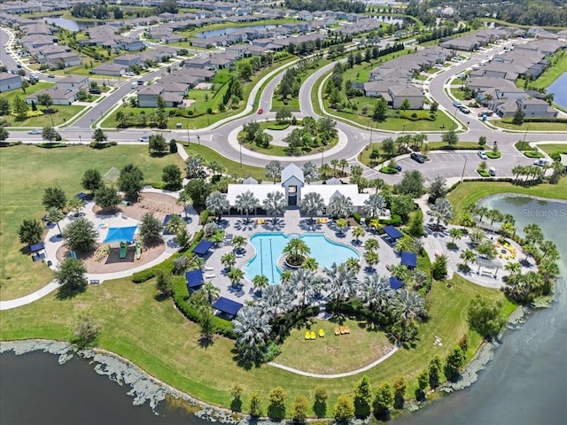drone / aerial view with a residential view and a water view