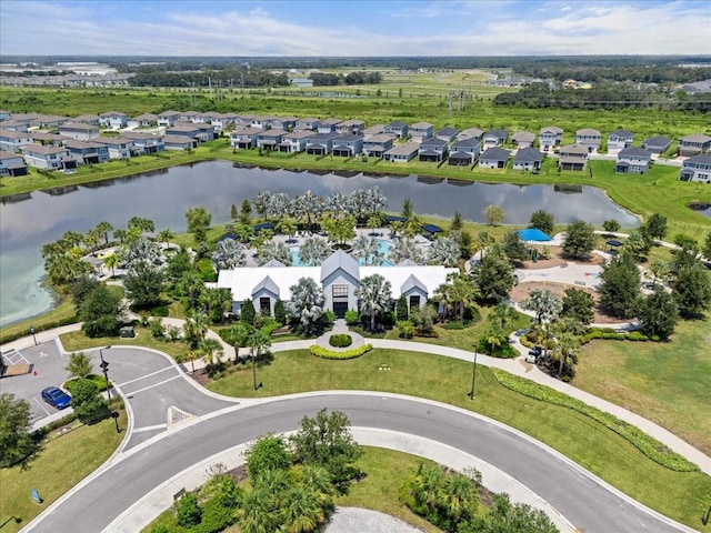 birds eye view of property with a water view and a residential view