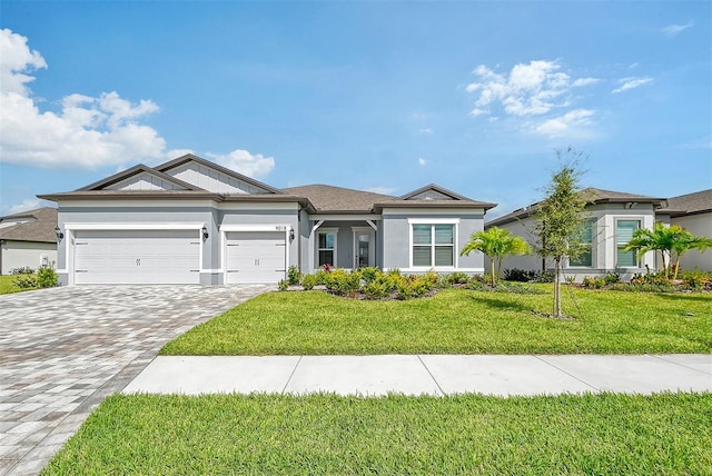 single story home with a garage and a front lawn