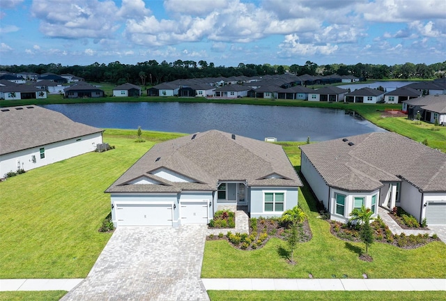 exterior space featuring a water view, a front yard, and a garage