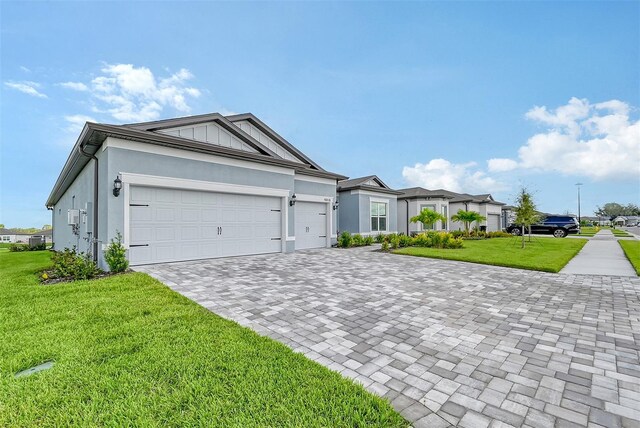 ranch-style house with a garage and a front yard