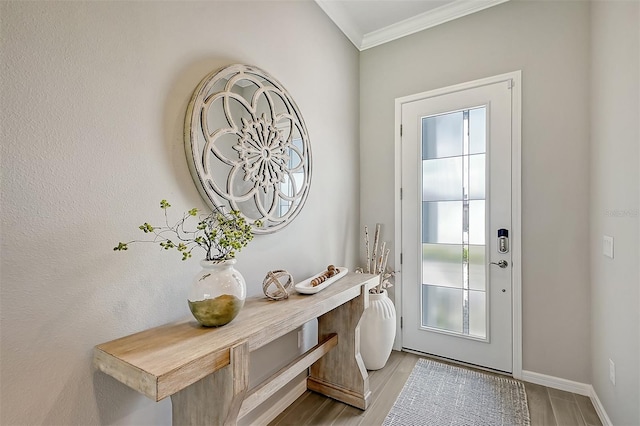 entryway featuring light wood-type flooring and crown molding