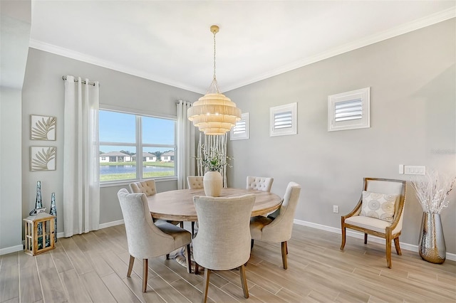 dining area featuring light hardwood / wood-style flooring, a chandelier, and ornamental molding