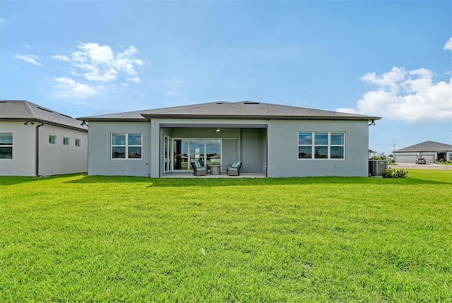 rear view of house featuring a patio and a yard