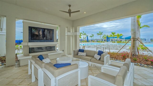 view of patio / terrace featuring an outdoor living space with a fireplace and a water view