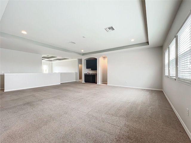 unfurnished living room featuring carpet flooring