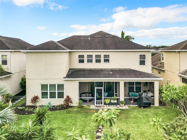 rear view of property with a lawn