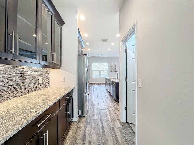 hall with light hardwood / wood-style flooring and sink