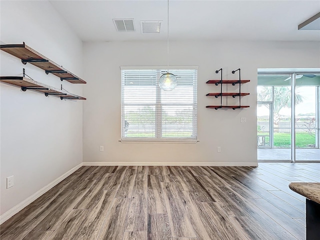 unfurnished room with wood-type flooring