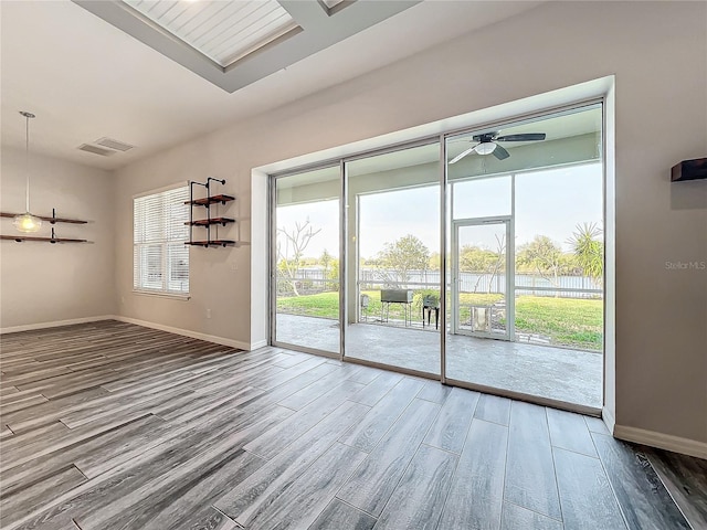 unfurnished room featuring hardwood / wood-style floors and ceiling fan