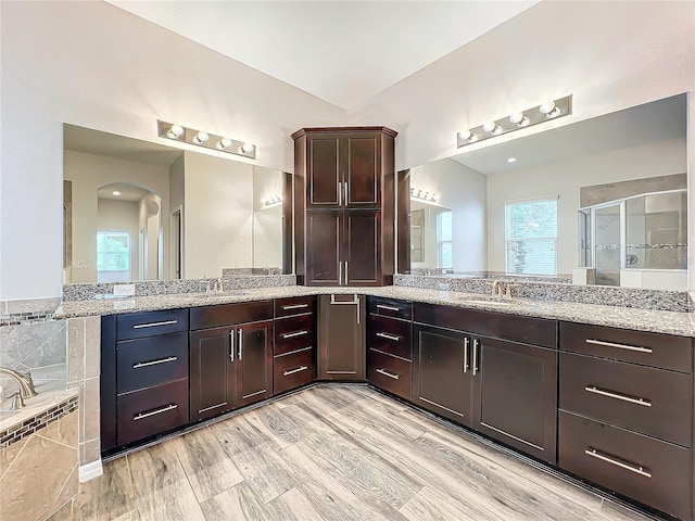 bathroom featuring shower with separate bathtub, vanity, and hardwood / wood-style flooring