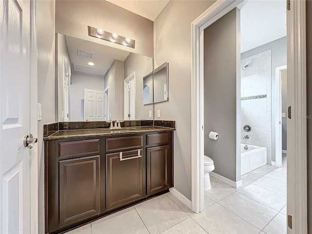 full bathroom featuring vanity, tile patterned floors, tiled shower / bath combo, and toilet