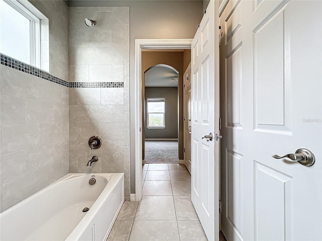 bathroom with tile patterned floors and tiled shower / bath