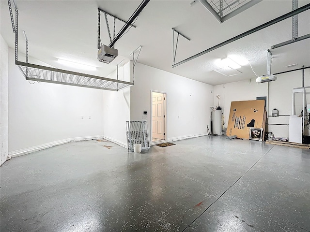 garage featuring water heater and a garage door opener